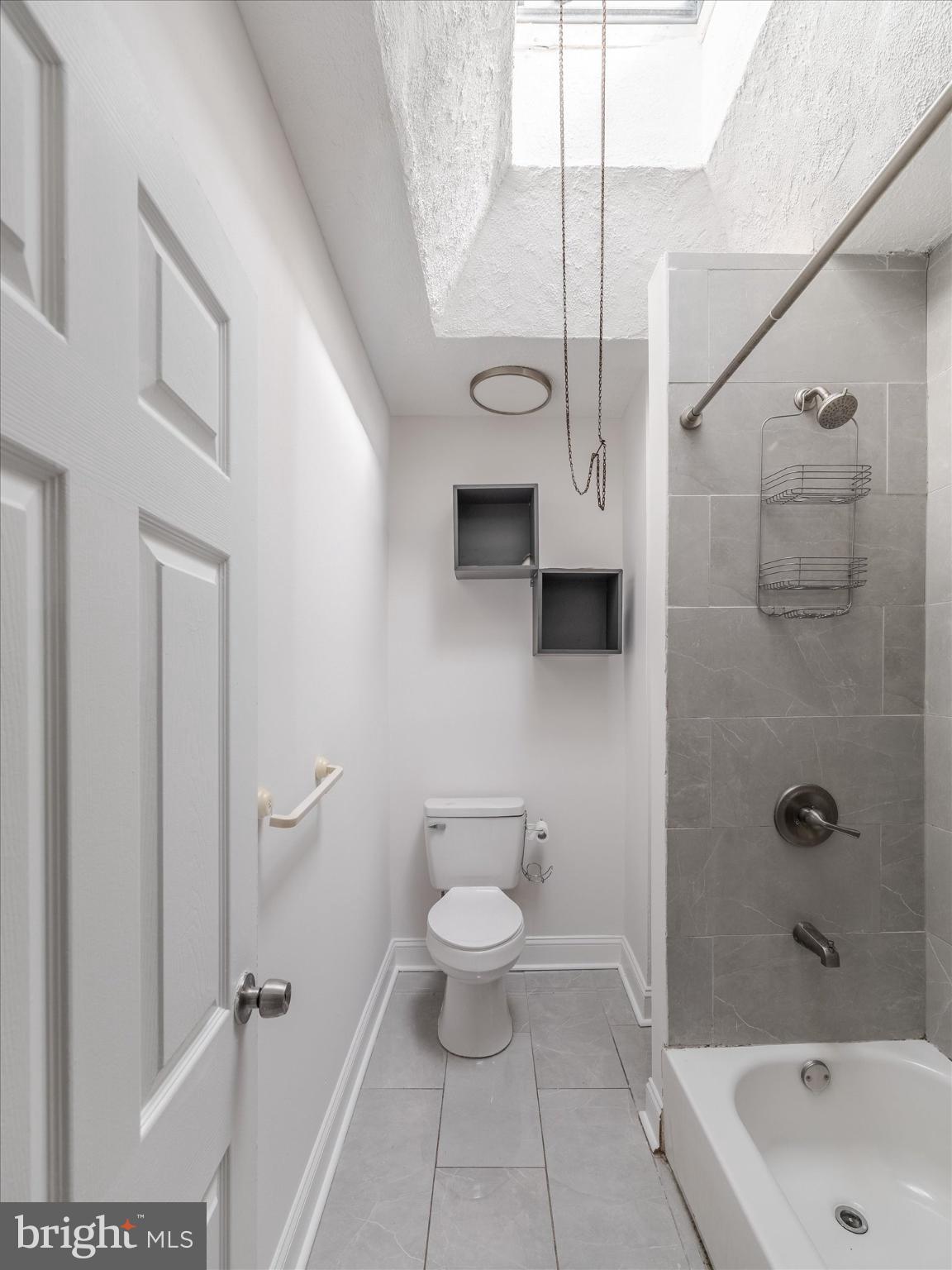 5428 Belmar Street Philadelphia, PA 19143 - Photo 21 of 25 a bathroom with a white toilet and a shower