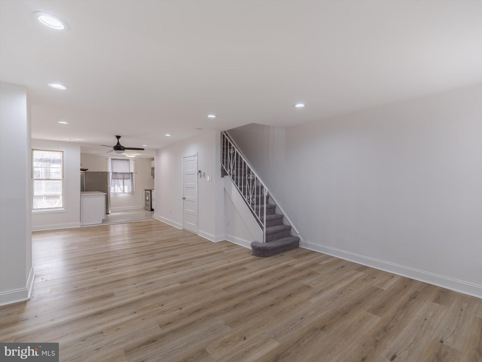 5428 Belmar Street Philadelphia, PA 19143 - Photo 4 of 25 a view of an empty room with wooden floor and a window