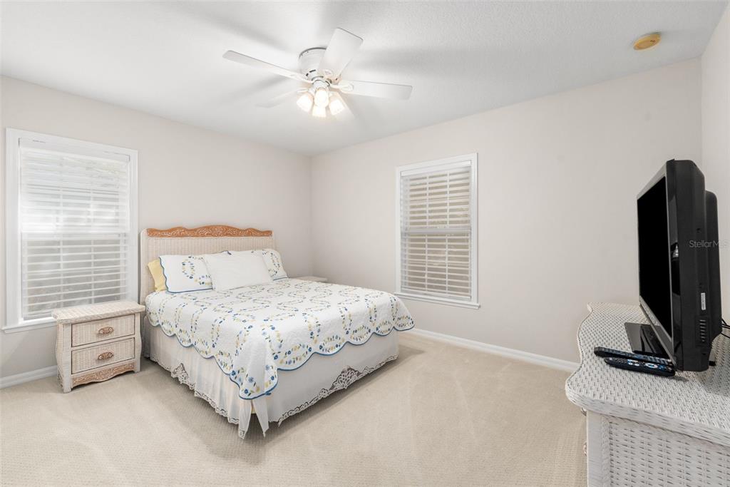 7418 White Oaks Road Alachua, FL 32615 - Photo 24 of 46 a bedroom with a bed a flat screen tv and dresser
