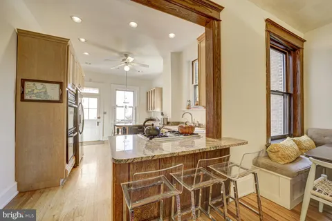 a kitchen with a stove a sink and cabinets