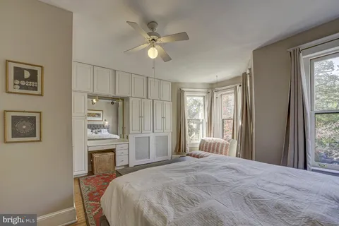 a living room with furniture and large windows