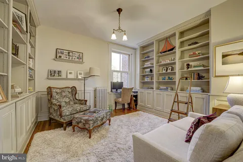 a living room with a bed furniture and a window