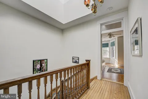 a view of a livingroom with wooden floor and a flat screen tv