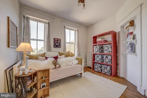 a living room with furniture a fireplace and a potted plant