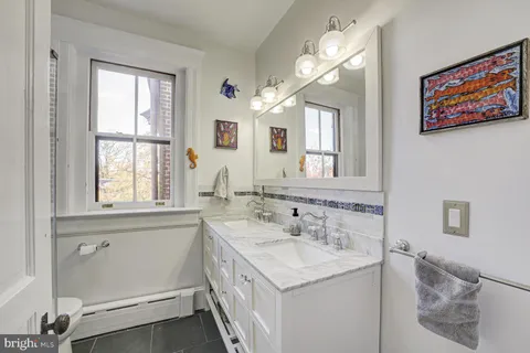 a kitchen with granite countertop a stove and a wooden floor