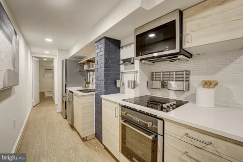 a bathroom with a sink toilet vanity and tub