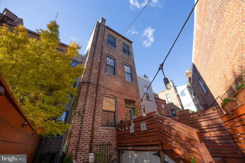 a front view of a building with outdoor seating