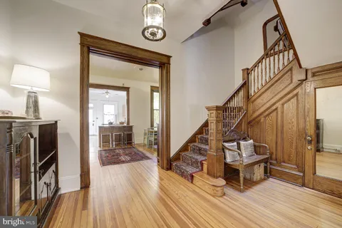 a view of a hallway with wooden floor and glass door