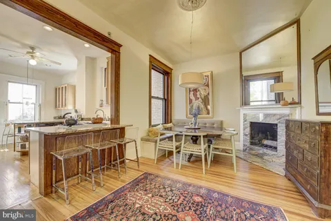 a living room with furniture a fireplace and wooden floor