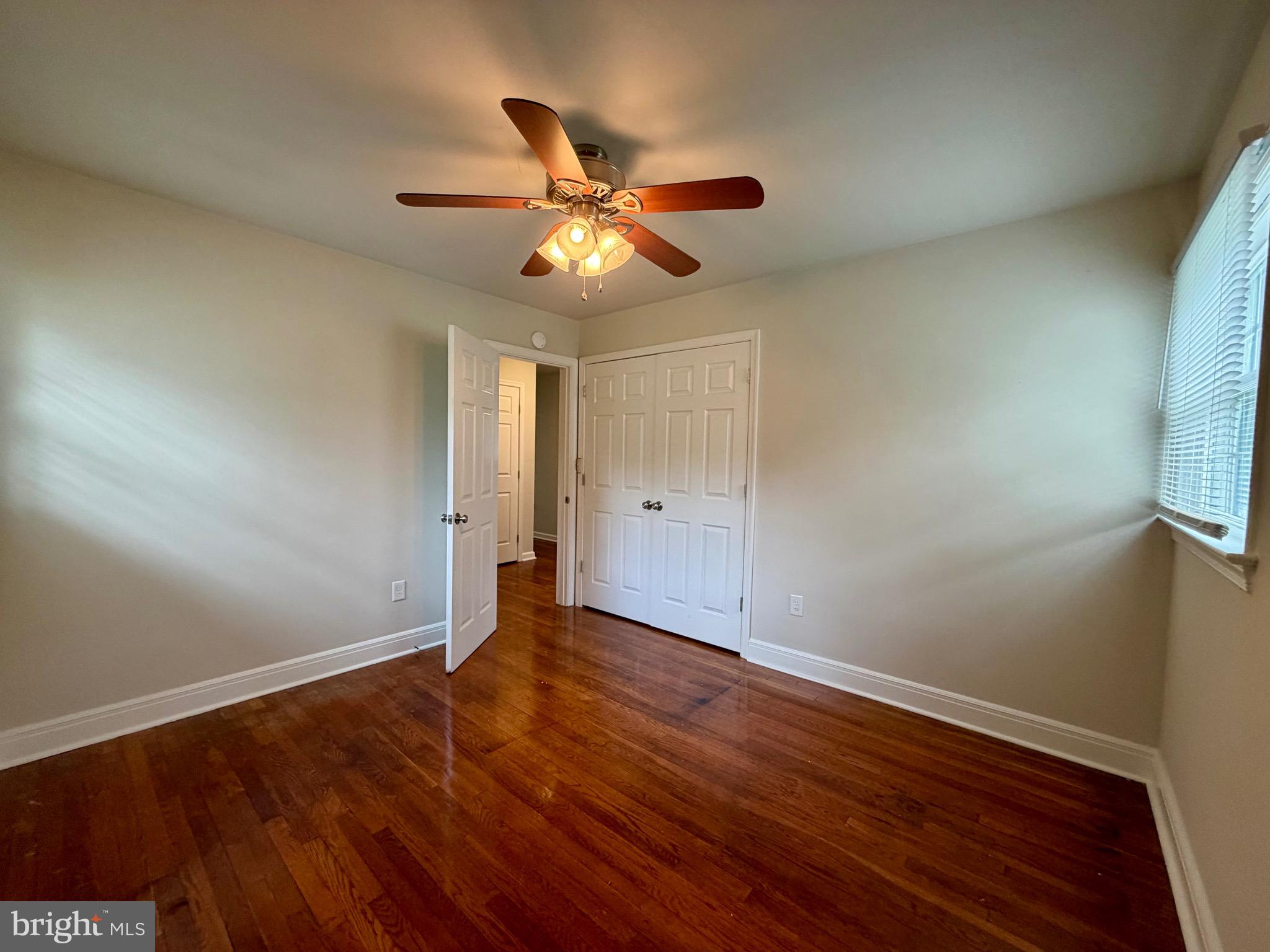 1010 Nottingham Street Culpeper, VA 22701 - Photo 7 of 21 an empty room with wooden floor fan and windows
