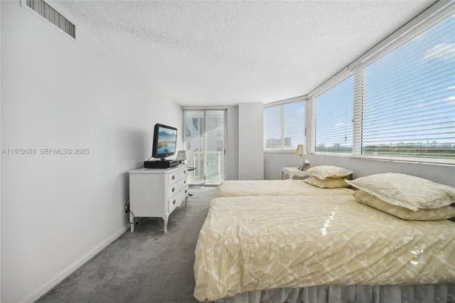a bathroom with a granite countertop sink mirror and bathtub