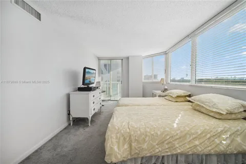 a bathroom with a granite countertop sink mirror and bathtub