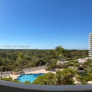 a view of ocean with green space