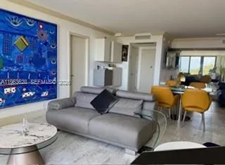 a living room with couches and a flat screen tv