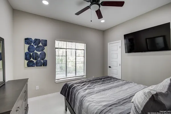 a bedroom with a bed and a television