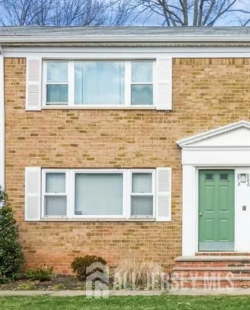 a view of a brick house with a yard