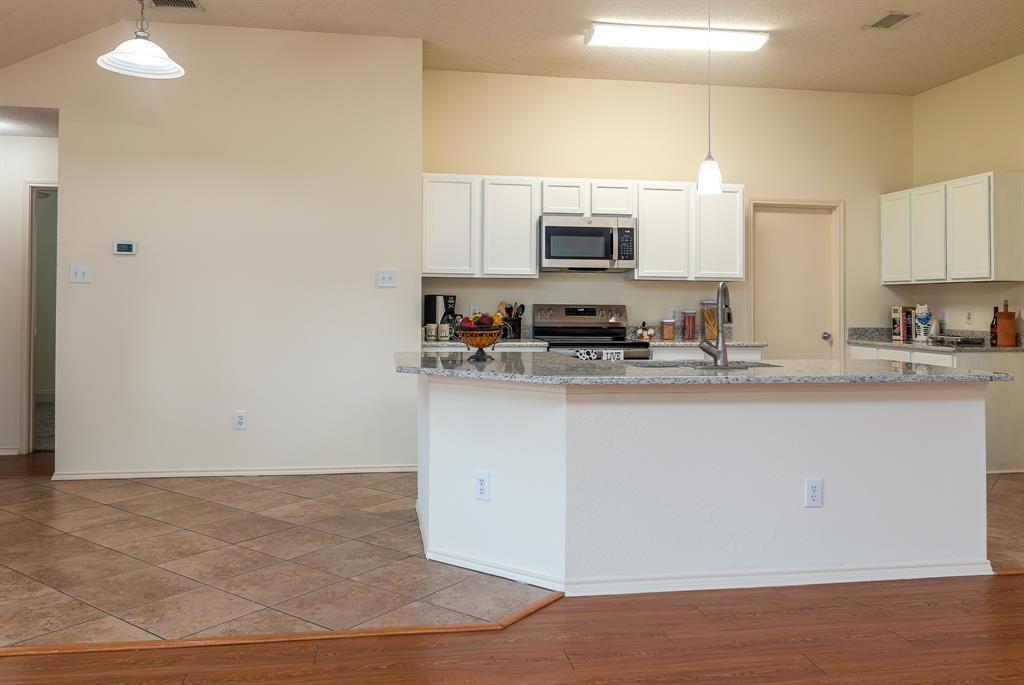 107 Hazelnut Trail Forney, TX 75126 - Photo 10 of 37 Kitchen renovations include fresh white painted cabinetry, granite, slide in range, and recent dishwasher.