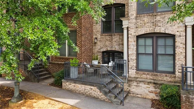a view of a patio with table and chairs with a fire pit and potted plants