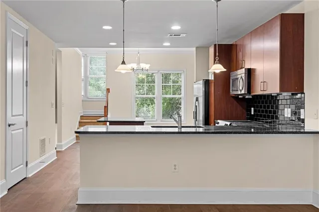 a large kitchen with a large window appliances and cabinets
