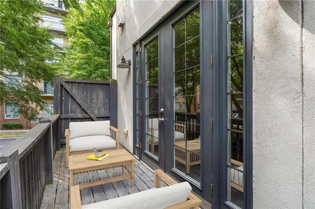 a view of balcony with furniture and garden