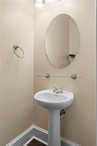 a bathroom with a sink a mirror and shower