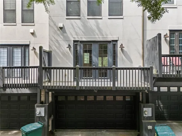 a view of a brick house with wooden fence