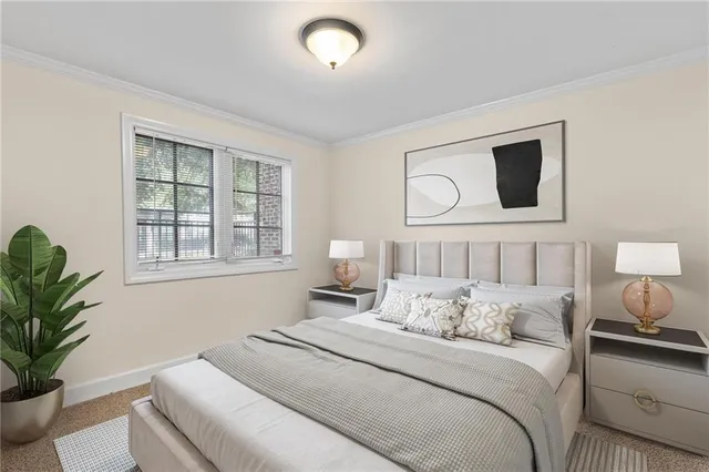 a bedroom with a large bed and a potted plant
