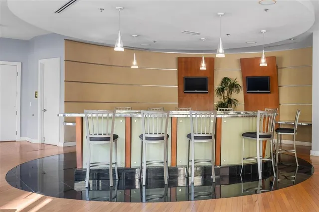 a living room with furniture a large window and a chandelier