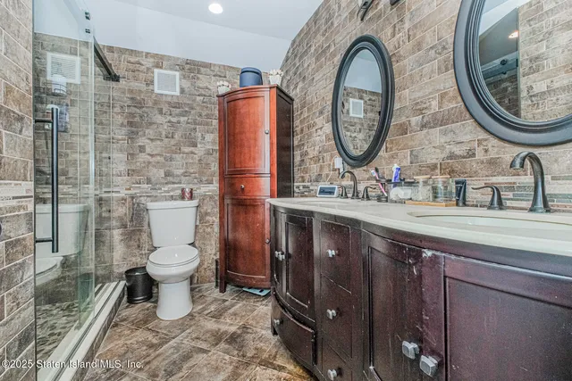 a bathroom with a toilet a sink and a mirror