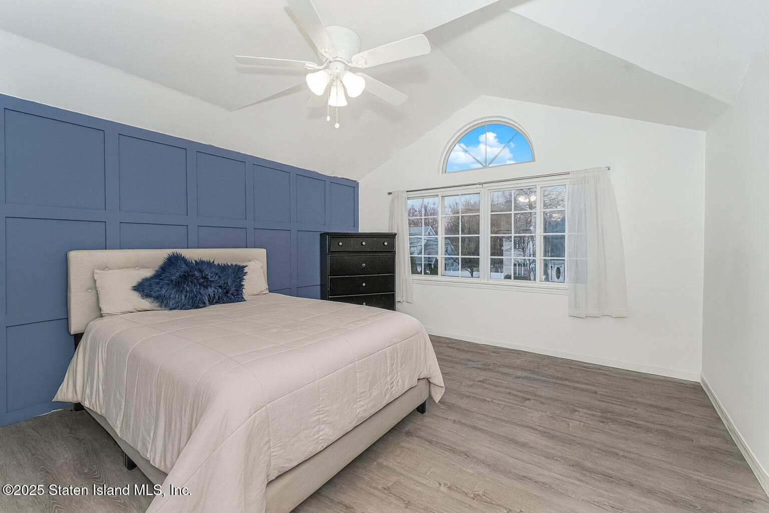 122 Clay Pit Road Staten Island, NY 10309 - Photo 15 of 26 a bedroom with a large bed and a tv