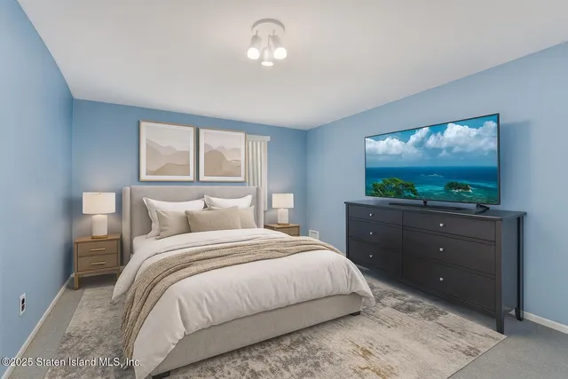 a bedroom with a bed and a flat screen tv