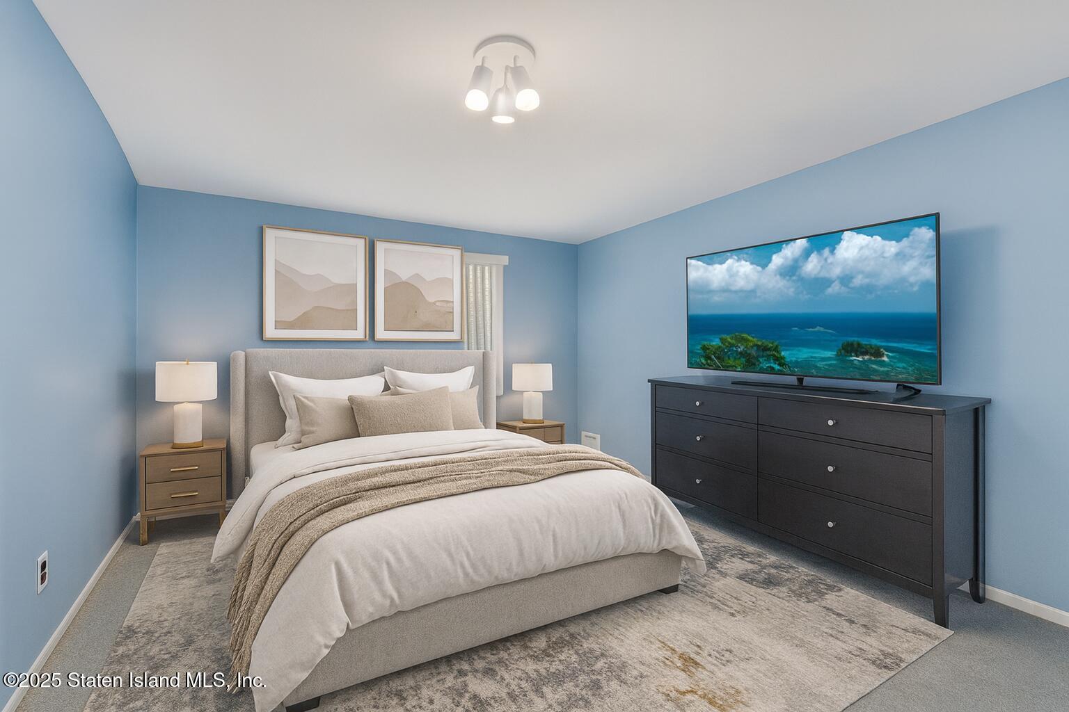 122 Clay Pit Road Staten Island, NY 10309 - Photo 17 of 26 a bedroom with a bed and a flat screen tv