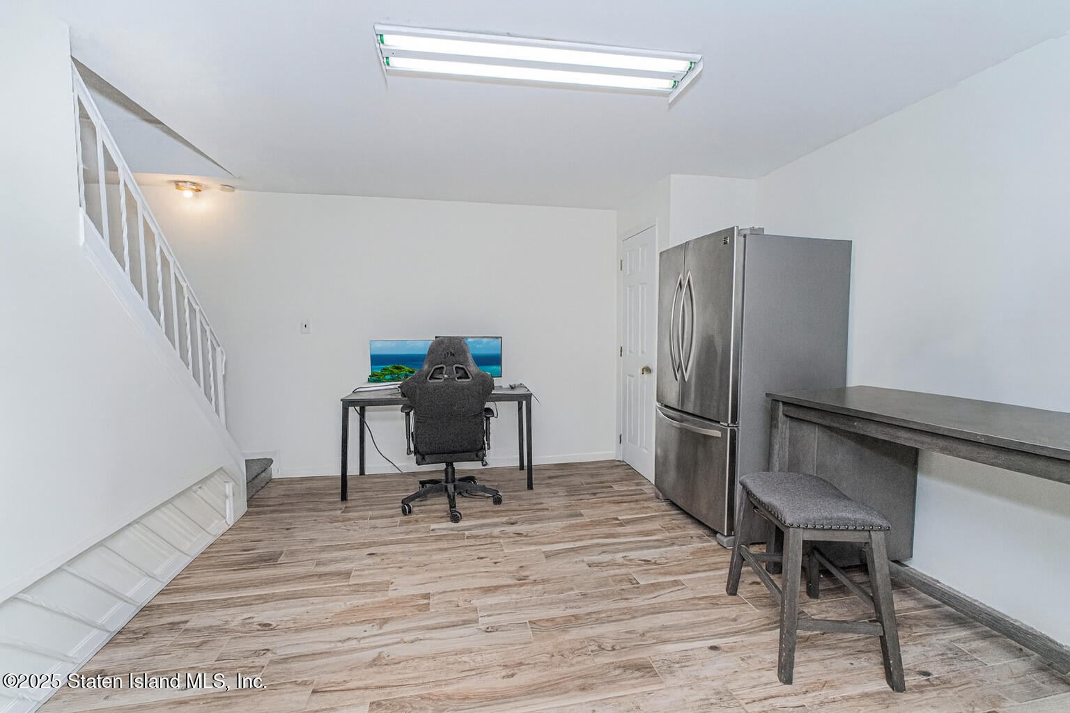 122 Clay Pit Road Staten Island, NY 10309 - Photo 18 of 26 a view of a workspace with furniture and a window