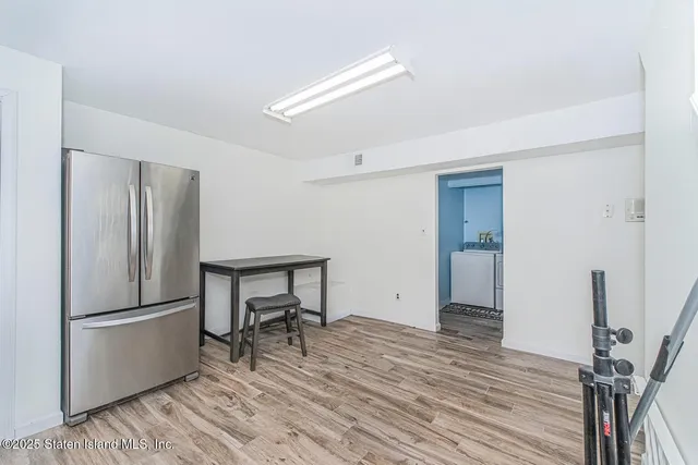 a room with a refrigerator and a table