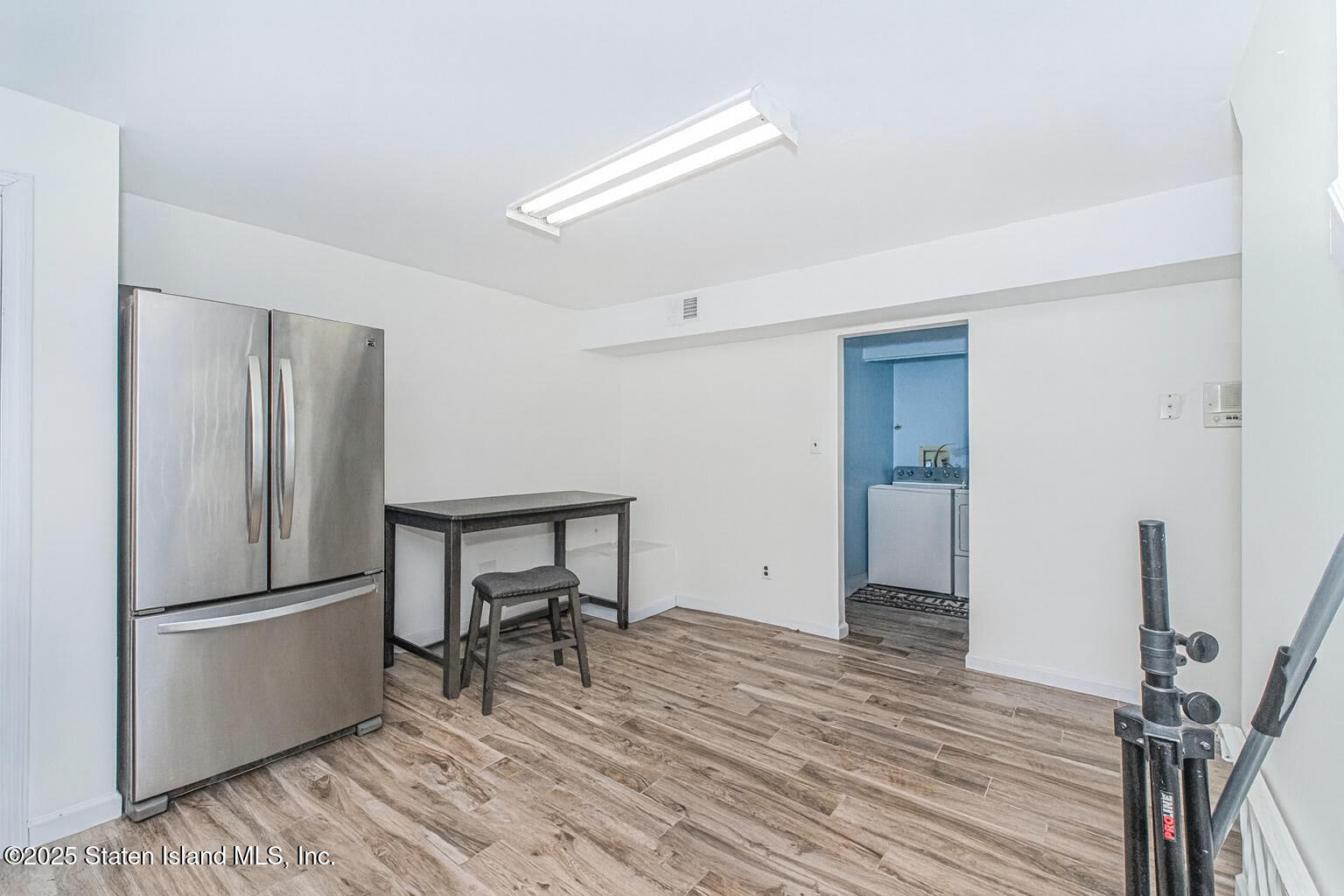 122 Clay Pit Road Staten Island, NY 10309 - Photo 19 of 26 a room with a refrigerator and a table