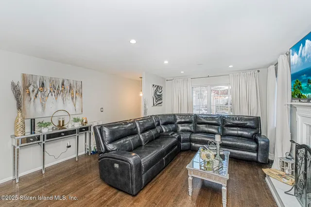 a view of living room kitchen with furniture and wooden floor