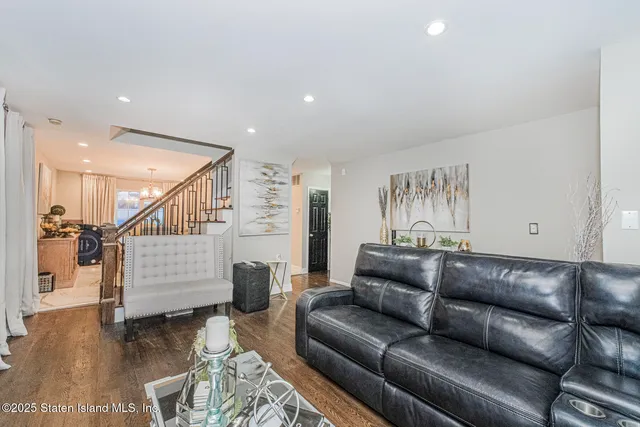 a living room with furniture and stairs
