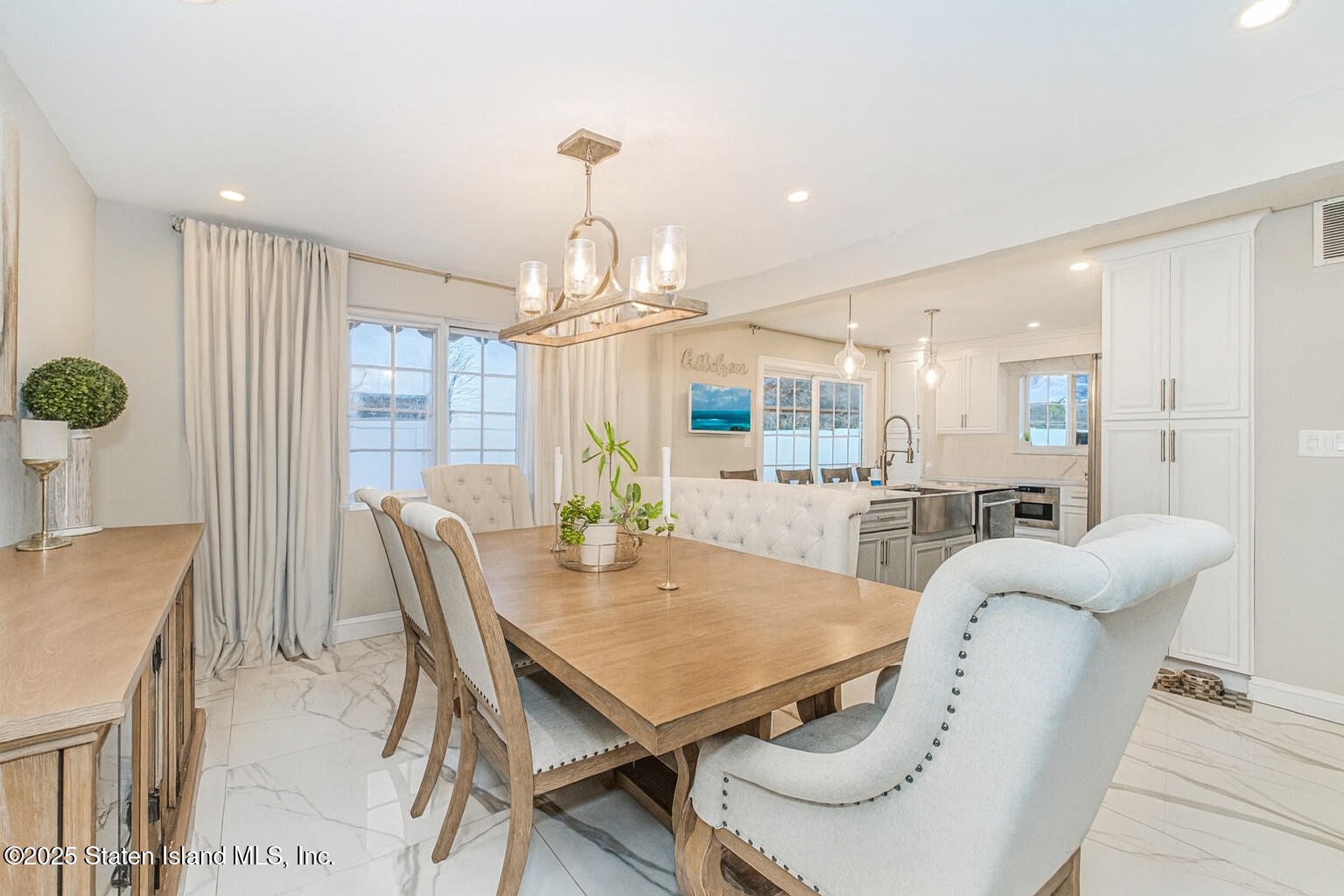 122 Clay Pit Road Staten Island, NY 10309 - Photo 5 of 26 a view of a dining room with furniture and wooden floor