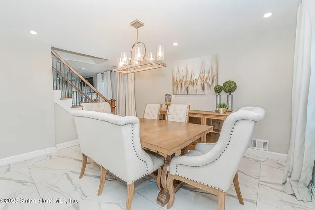 a view of a dining room with furniture and chandelier