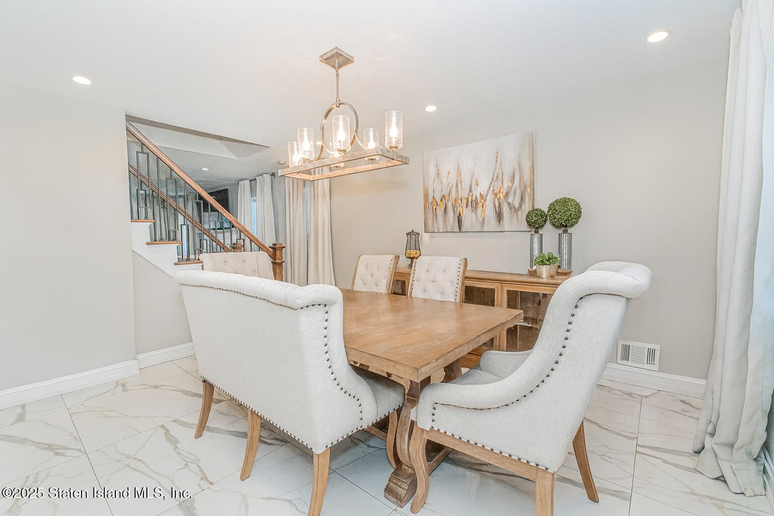122 Clay Pit Road Staten Island, NY 10309 - Photo 6 of 26 a view of a dining room with furniture and chandelier