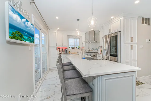 a large kitchen with a table and chairs
