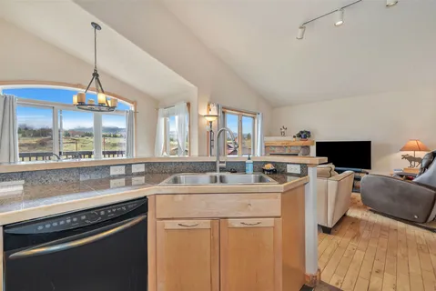 a kitchen with stainless steel appliances granite countertop a sink and a stove