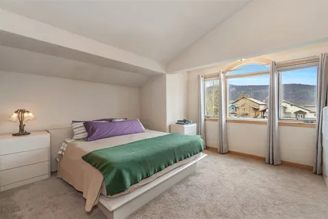 a bedroom with a bed and window
