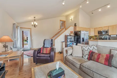 a living room with furniture and a chandelier
