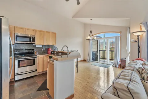 a kitchen with a stove a sink and a refrigerator