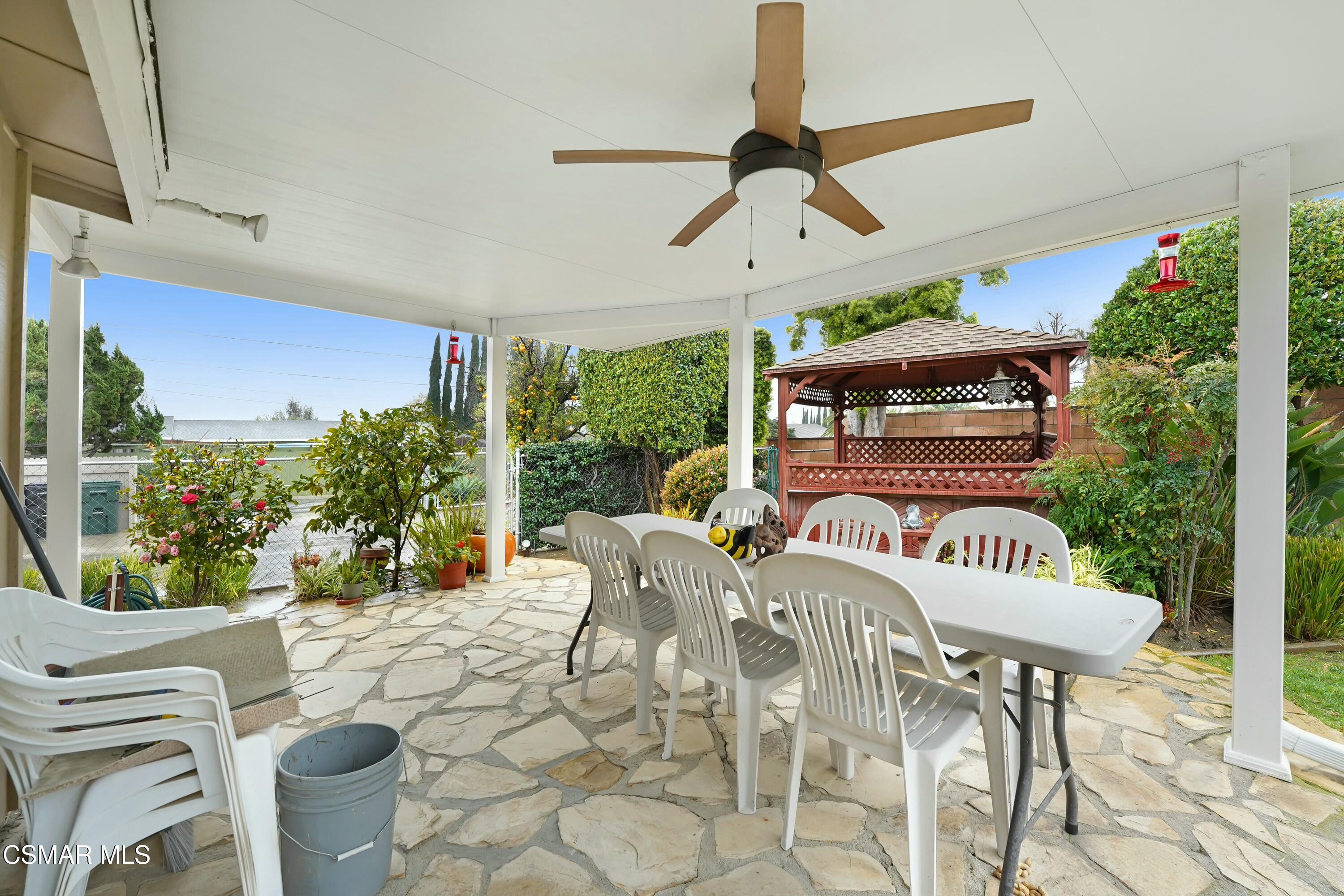 3075 Reservoir Drive Simi Valley, CA 93065 - Photo 16 of 20 a view of a patio with table and chairs