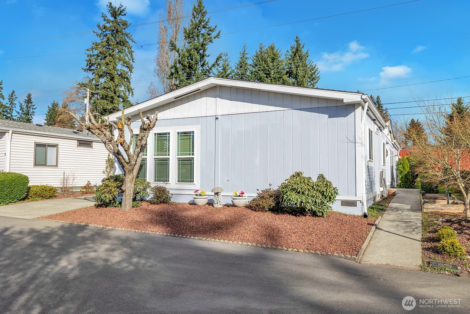 2611 South 288th Street, Unit 2 Federal Way, WA 98003 - Photo 1 of 22 a front view of a house with a yard and potted plants