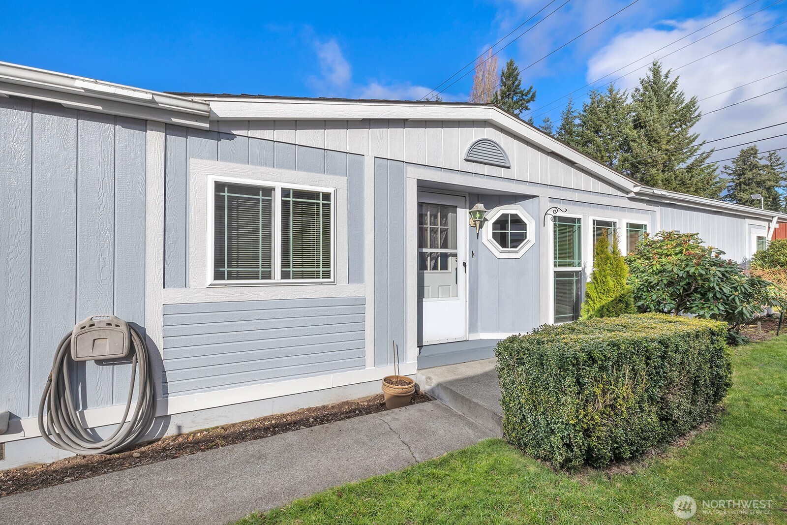2611 South 288th Street, Unit 2 Federal Way, WA 98003 - Photo 2 of 22 a front view of a house with garden