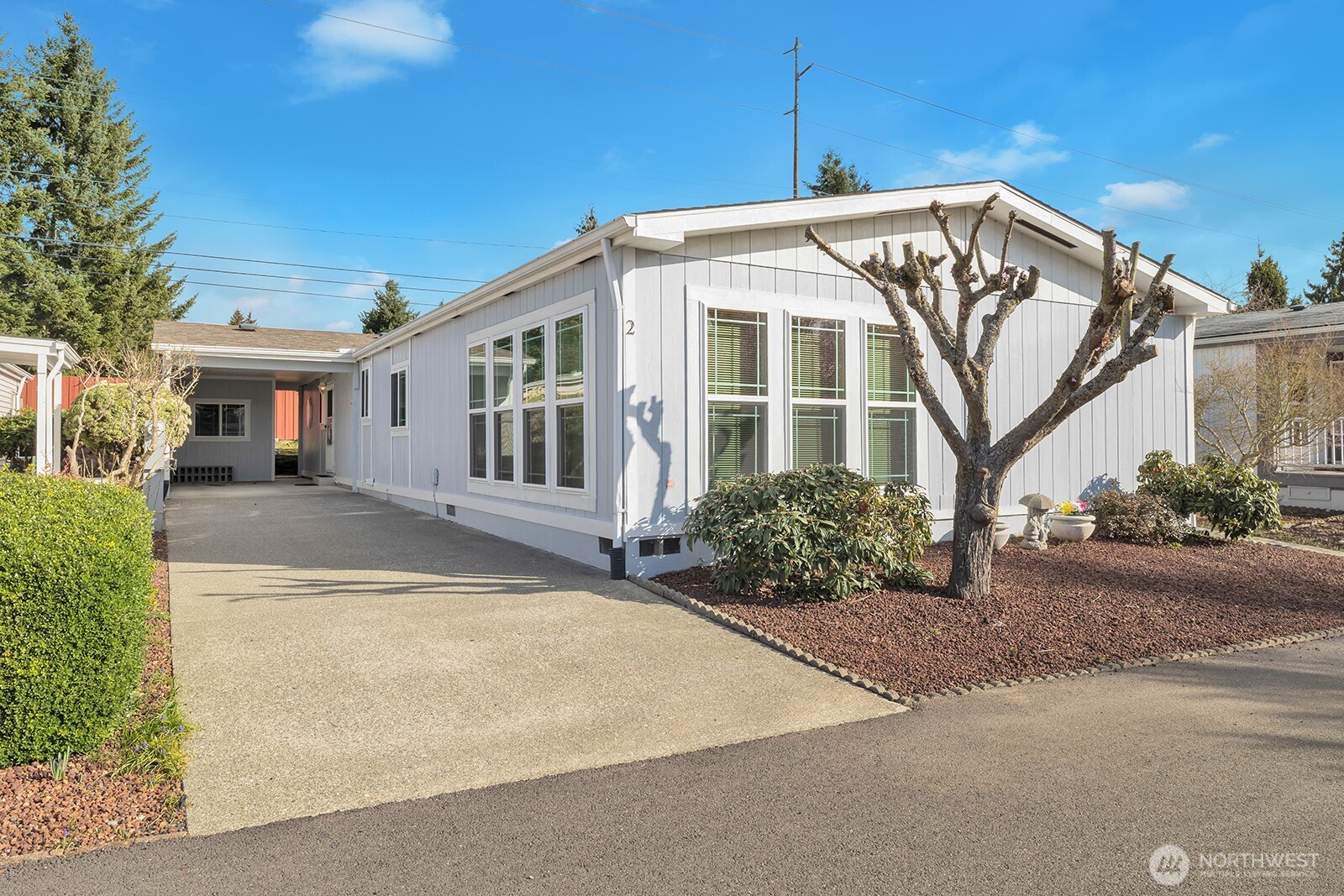 2611 South 288th Street, Unit 2 Federal Way, WA 98003 - Photo 3 of 22 a front view of a house with garden