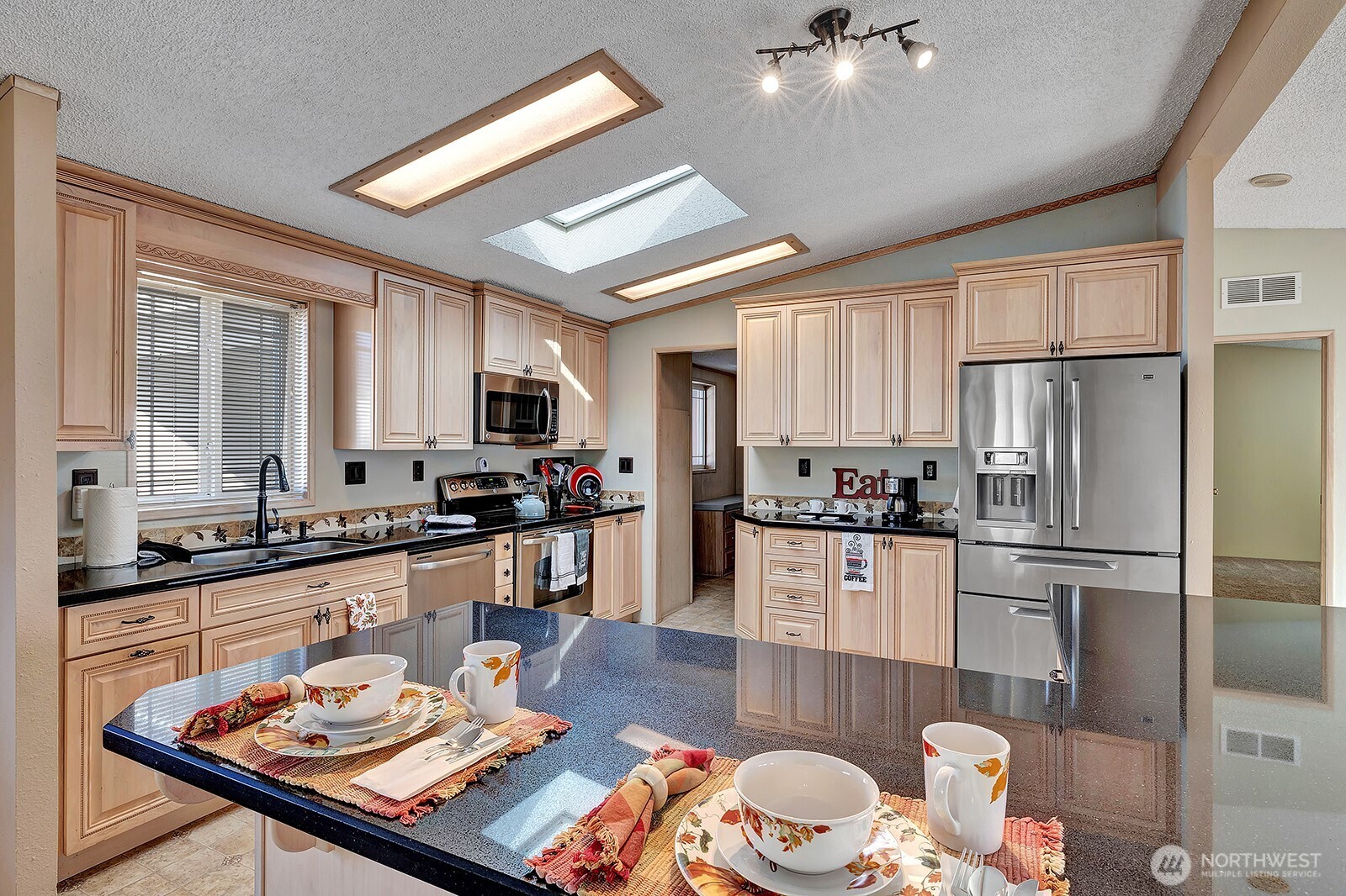 2611 South 288th Street, Unit 2 Federal Way, WA 98003 - Photo 6 of 22 a kitchen with a refrigerator a stove a sink dishwasher a dining table and chairs with wooden floor